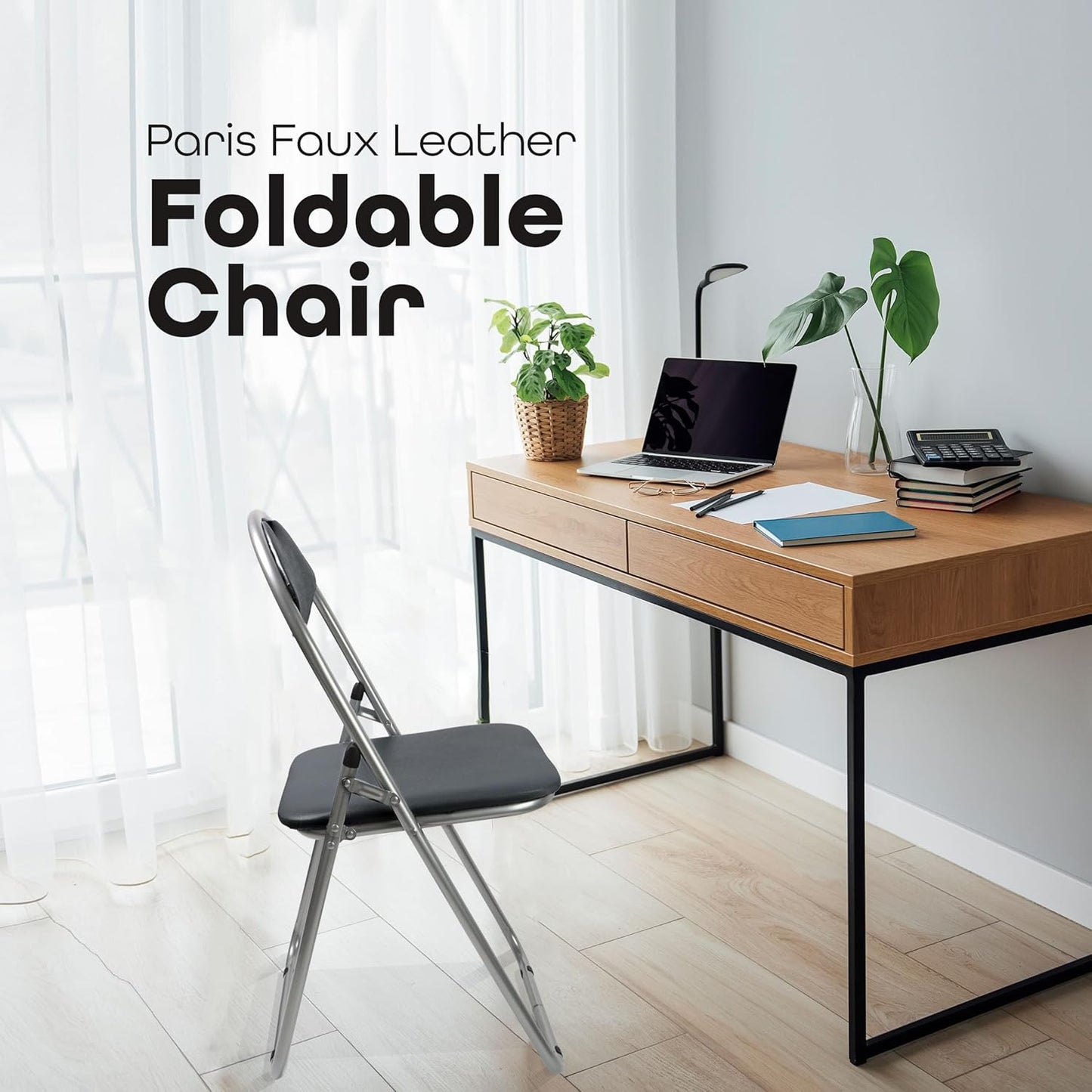 Foldable chair in front of a wooden desk with a laptop and plants in a bright room.