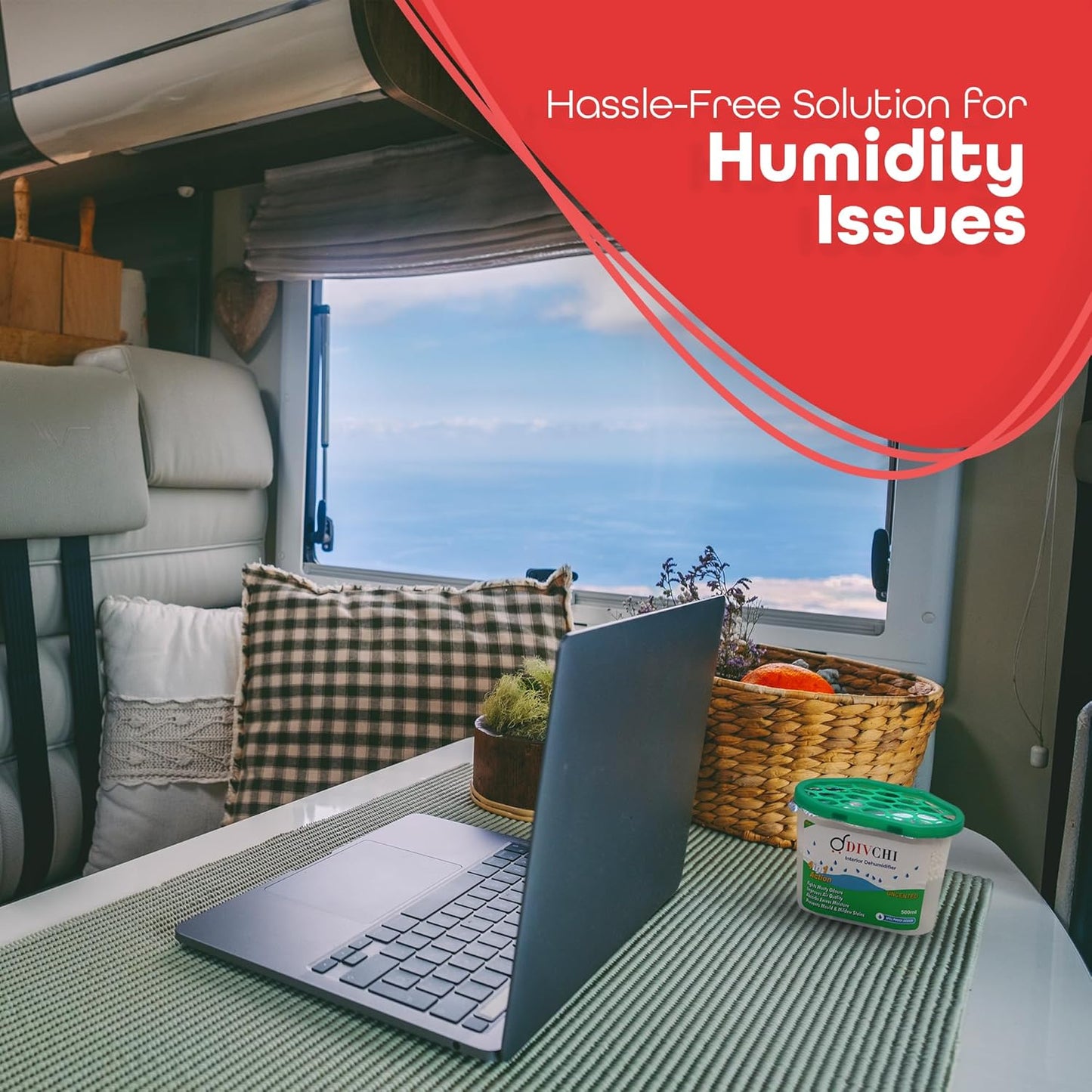 DIVCHI moisture absorber placed on a table in a caravan, next to a laptop and basket.