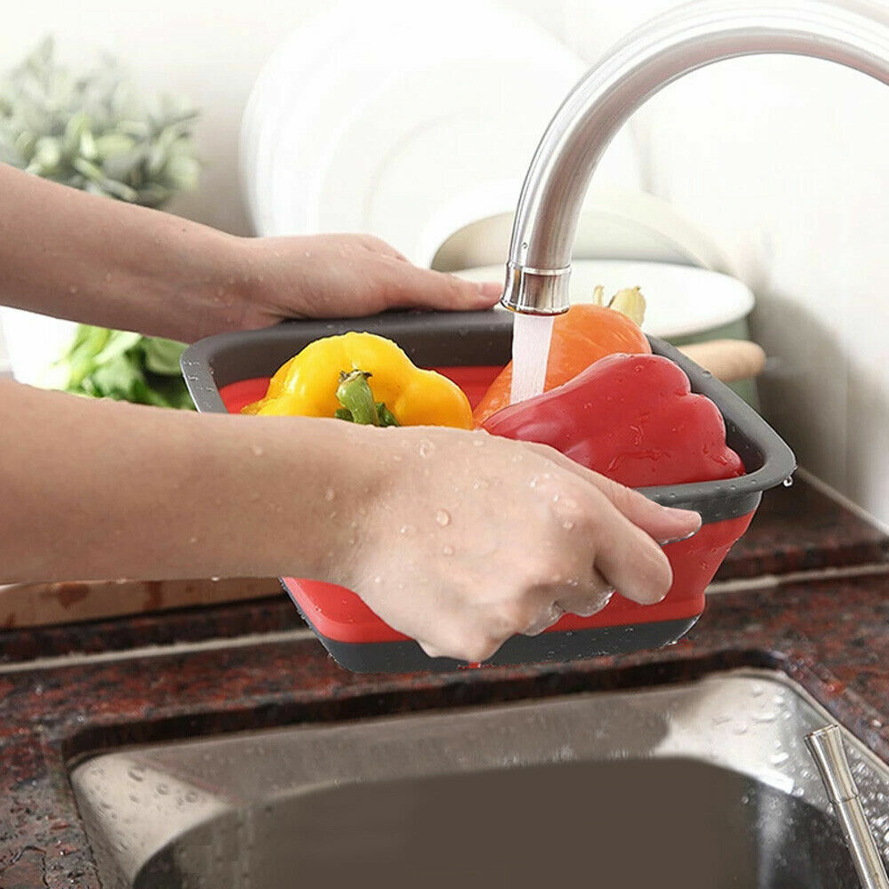 Washing vegetables in collapsible red bowl under tap