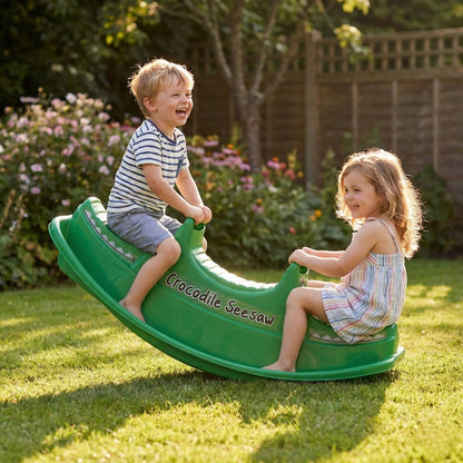 Two children laughing on the DIVCHI crocodile seesaw in the garden