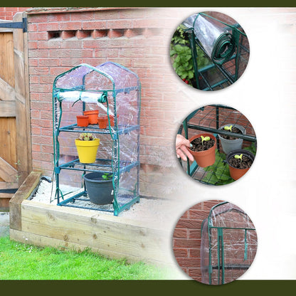 Portable greenhouse with plants and a roll of clear plastic against a brick wall.