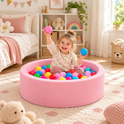 Toddler playing in a pink DIVCHI foam ball pit in a nursery (balls not included)