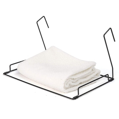 Folded white fleece cover and black metal frame for cat radiator bed.