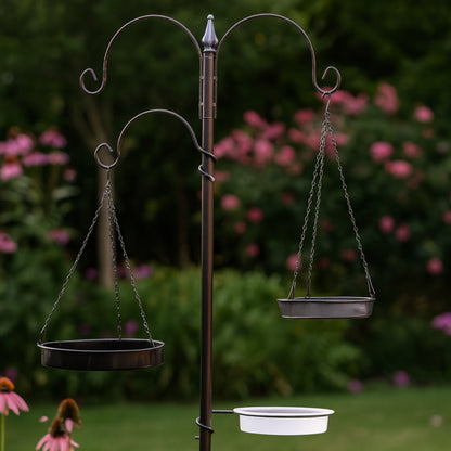 Bird feeder stand with hanging bird baths in a garden setting